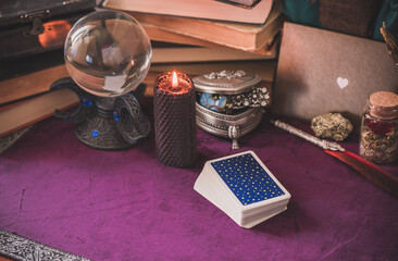 Tarot cards and candles, witch magic bottles . Wicca, esoteric, divination and occult background...