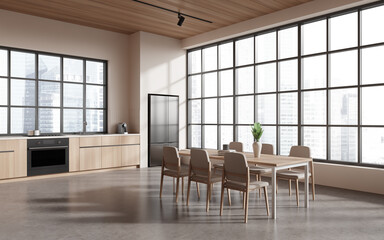 Fototapeta na wymiar Stylish kitchen interior with eating table, kitchenware and panoramic window