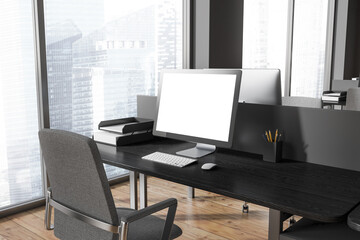 Mock up computer screen on gray and wooden office table
