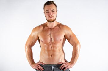 Fototapeta premium Young handsome guy on a diet. A man with a beautiful athletic body. 