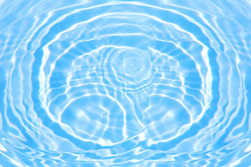 Blue water with ripples on the surface. Defocus blurred transparent blue colored clear calm water surface texture with splashes and bubbles. Water waves with shining pattern texture background.
