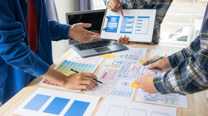 Close-up ux developers and ui designers use augmented reality to brainstorm on mobile app interface...