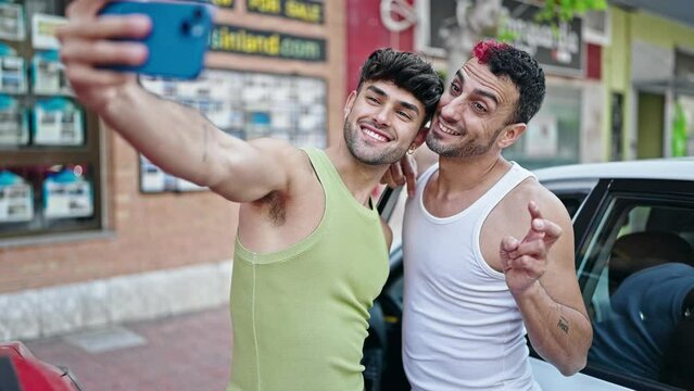 Two men couple make selfie by smartphone standing by car at street