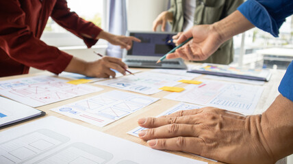 Close-up ux developers and ui designers use augmented reality to brainstorm on mobile app interface...