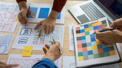 Close-up ux developers and ui designers use augmented reality to brainstorm on mobile app interface...