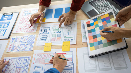 Close-up ux developers and ui designers use augmented reality to brainstorm on mobile app interface...