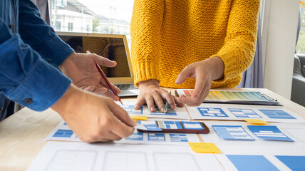 Close-up ux developers and ui designers use augmented reality to brainstorm on mobile app interface...