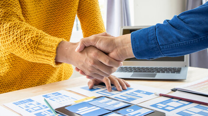 Close-up ux developers and ui designers use augmented reality to brainstorm on mobile app interface...
