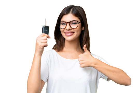 Young Russian woman holding car keys over isolated chroma key background with thumbs up because something good has happened