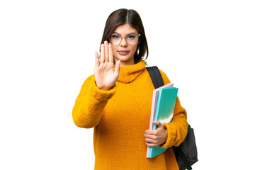 Young student woman over isolated chroma key background making stop gesture
