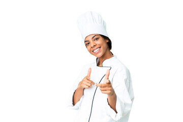 Young African American chef over isolated chroma key background pointing to the front and smiling