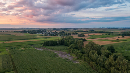 Fototapeta na wymiar Sunset aerial landscape of filds and meadows