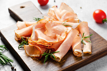 Cured Meat Platter, Prosciutto Crudo or Jamon with Spices, Antipasto, Appetizer over Bright Concrete Background