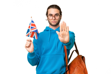 Young handsome man holding an United Kingdom flag over isolated background making stop gesture