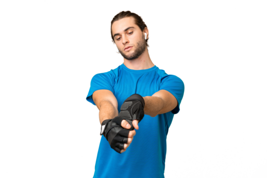 Young handsome man isolated on green chroma background stretching arm