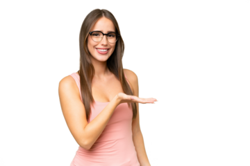 Young pretty caucasian woman over isolated background presenting an idea while looking smiling towards