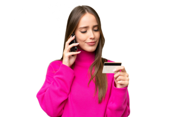 Young beautiful caucasian woman over isolated background buying with the mobile with a credit card