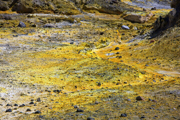 Closeup of a yellow sulphuric surface with crystels on the floor at a volcanic crater