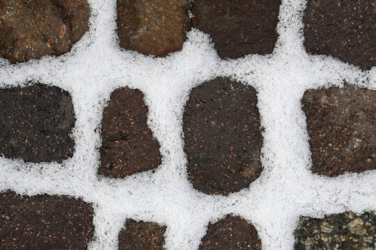Snow filling all gaps of stones ofw a walkway