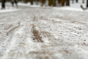 close up of a path in a park covered with snow and gravel