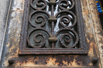 Rust deteriorations. Really old and decrepit door from a century-old cemetery (Père Lachaise, France)