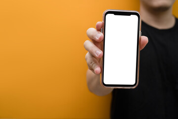 Closeup view of man hand holding mockup smartphone. Blank screen for your own webpage or advertise text
