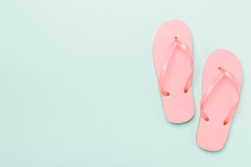 Bright flip flops on color background, top view