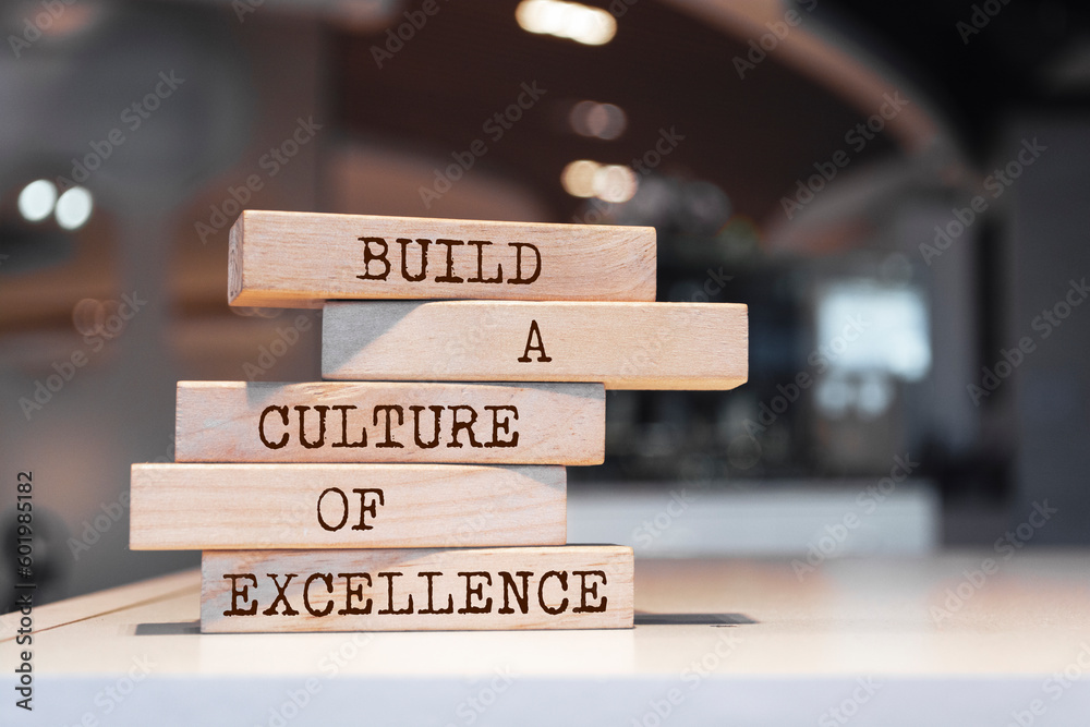 Wall mural wooden blocks with words 'build a culture of excellence'.