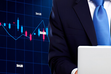 Businessman use laptop on digital indicators and declining graphs of stock market crash background