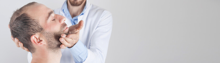 Obraz premium Caucasian doctor massaging patient head.