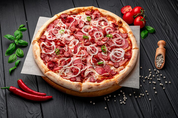 Spicy pizza with ham, sausage, jalapeno peppers and onions.