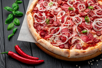 Spicy pizza with ham, sausage, jalapeno peppers and onions.