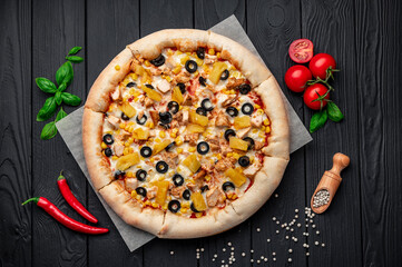 Delicious pizza with chicken meat, pineapple, corn and olives