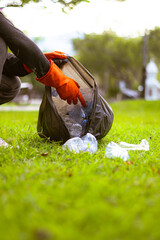 Man picking up plastic waste to clean up at a park