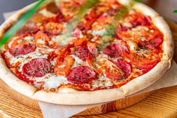 Tasty pizza and cooking ingredients tomatoes basil