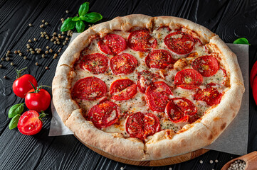 Pizza Margherita on black background, top view. Pizza Margarita with Tomatoes, Basil and Mozzarella Cheese