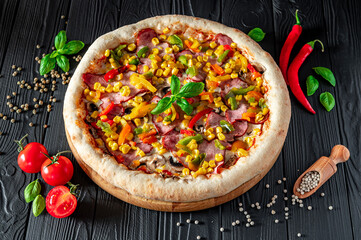 Tasty and big pizza with different types of meat. Pizza with different types of ingredients, sweet paprika and mushrooms