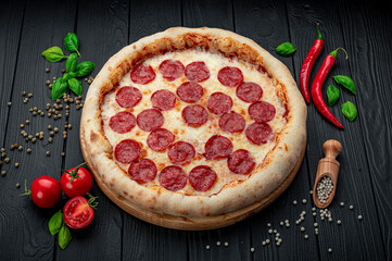 Tasty pepperoni pizza and cooking ingredients tomatoes basil