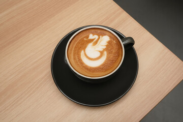 A cup of hot latte coffee on the table for breakfast

