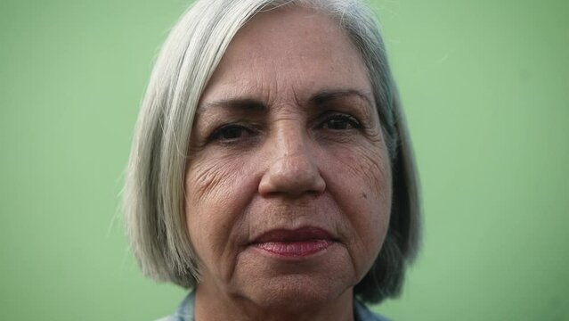 Senior woman looking into the camera - Elderly people lifestyle concept - Close up headshot 
