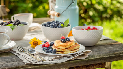 Delicious and homemade american pancakes with honey and blueberries.