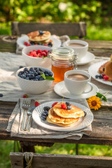 Tasty and sweet american pancakes with honey and blueberries.