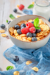 Sweet cornflakes with milk an fruits as healthy meal.