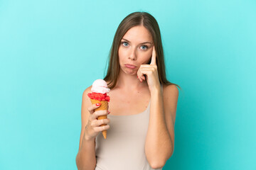 Young Lithuanian woman with cornet ice cream isolated on blue background thinking an idea