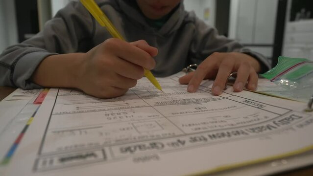 Child Doing Math Homework; Front Low Angle View.