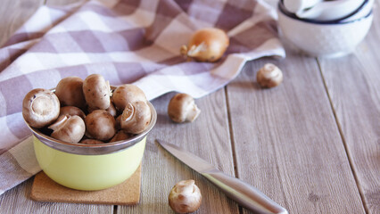 fresh champignons in a yellow bowl on the kitchen table