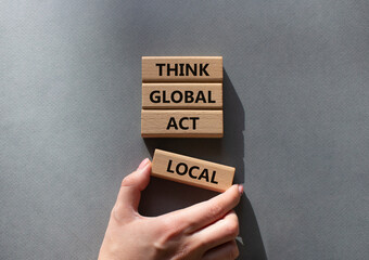 Think global act local symbol. Wooden blocks with words Think global act local . Beautiful grey...