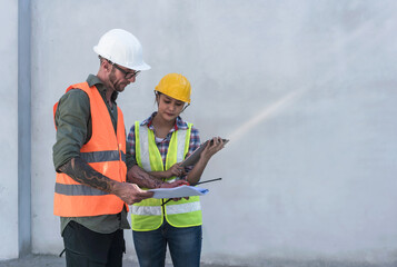 Male Engineer Construction working with foreman woman in house construction site