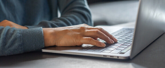 Woman working with modern laptop computer on desktop screen for advertising, mockup, technology, advertising, search information, creative design, learning, webinar, study, watching on table.