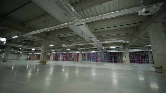 Construction process of a big, modern warehouse with multiple garage gates for easy access and transportation of goods.
